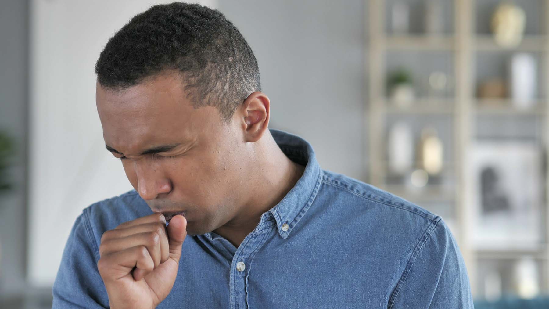 A man coughing and sneezing