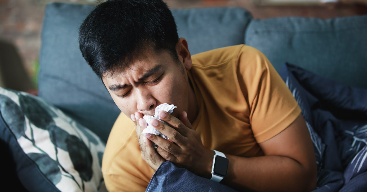 A person coughing with the flu/seasonal influenza.