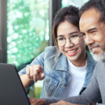 A care finder supporting an older person using a laptop to navigate potential aged care services.
