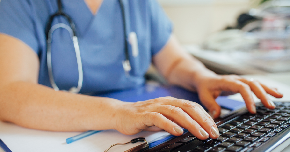 Doctor typing on computer