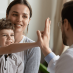MyMedicare - doctor high fiving a child with mother
