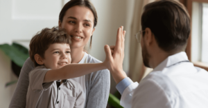 MyMedicare - doctor high fiving a child with mother