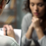 A general practice staff member provides support to a patient experiencing family violence