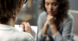 A general practice staff member provides support to a patient experiencing family violence