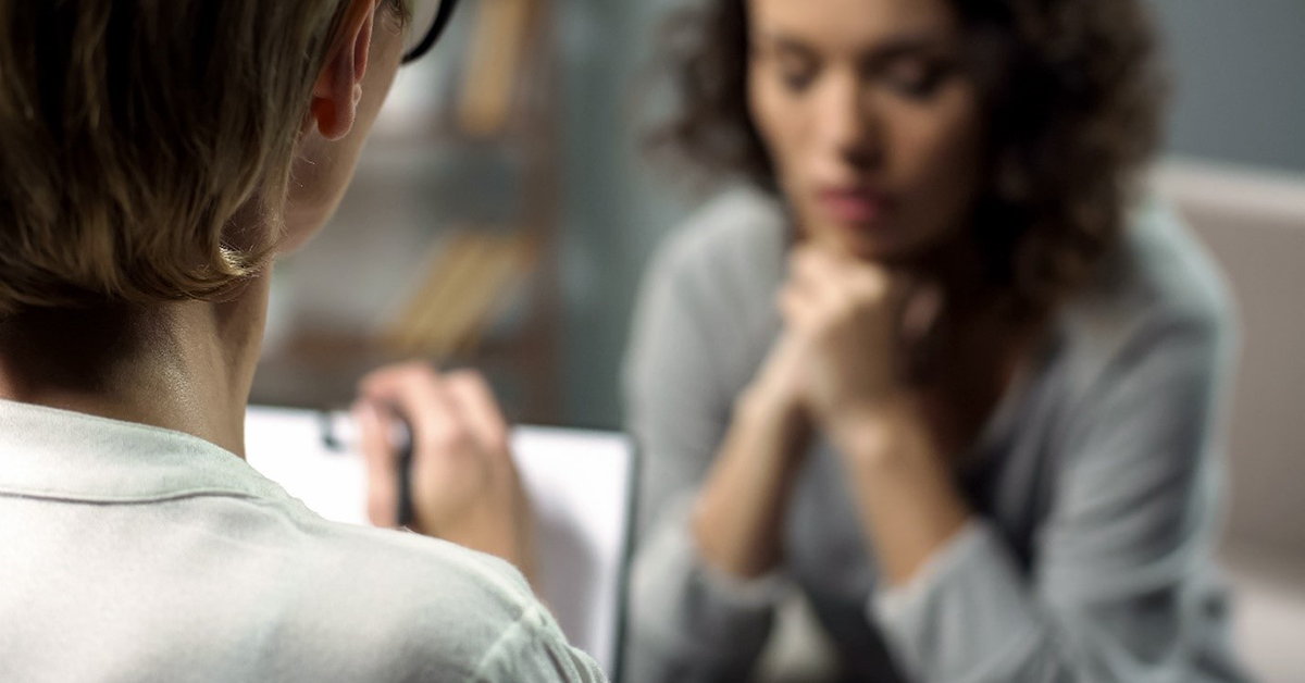 A general practice staff member provides support to a patient experiencing family violence