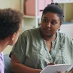 A clinician speaks with a child about their mental health