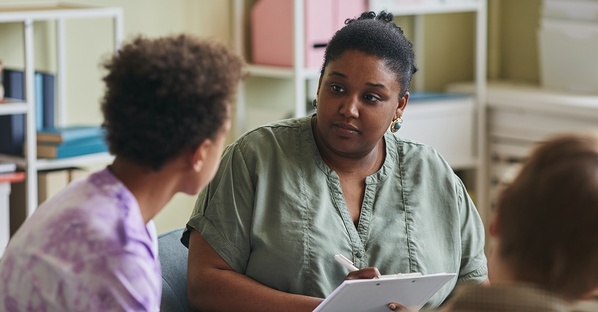 A clinician speaks with a child about their mental health