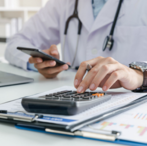 General practitioner works on calculator