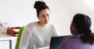 A health professional speaks with a person experiencing family violence
