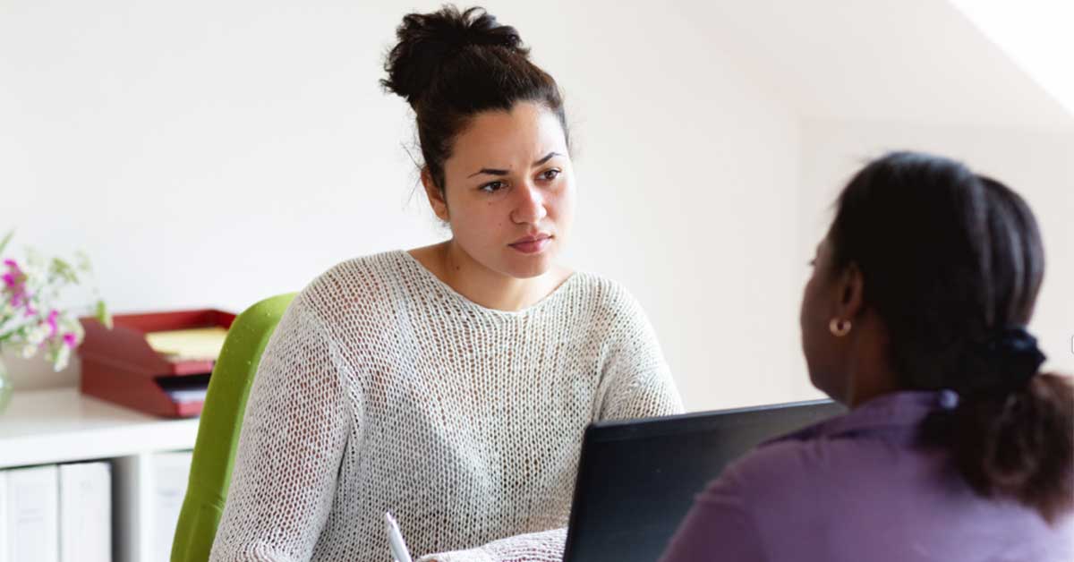 A health professional speaks with a person experiencing family violence