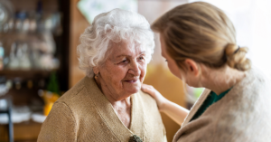 Female doctor visits a senior woman during visit to a residential aged care home